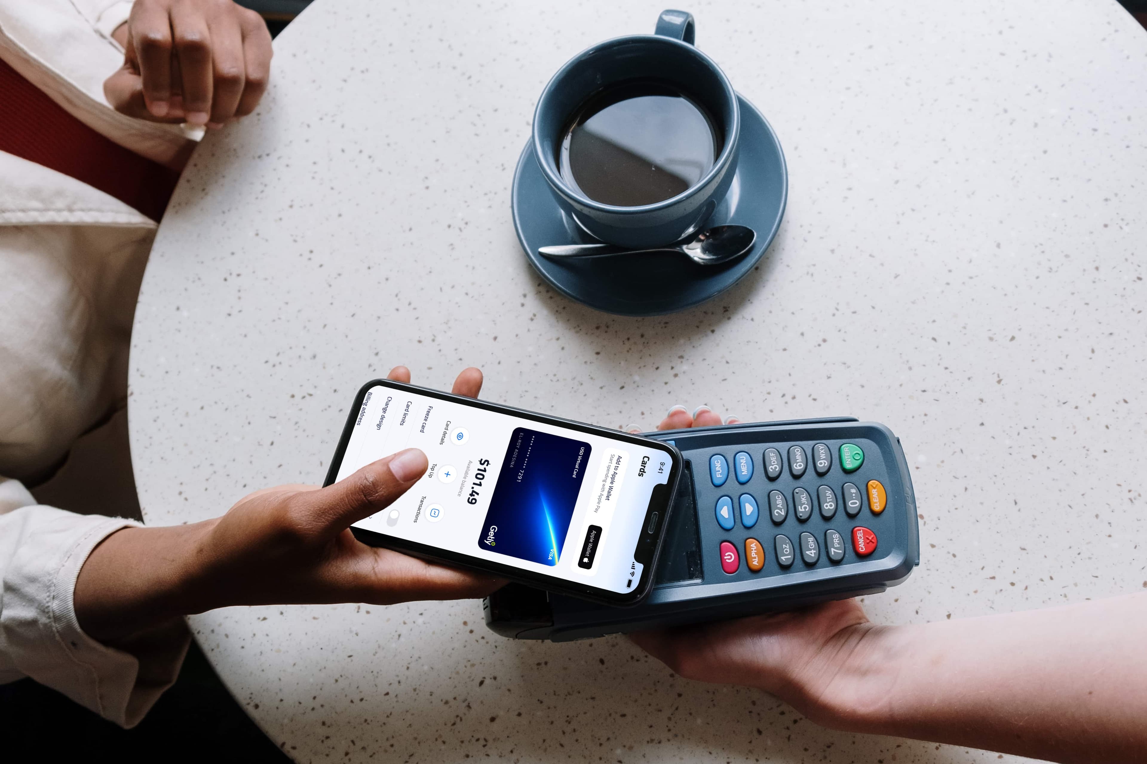 Tapping a phone to pay contactless with Apple Pay at a merchant terminal